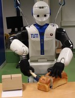 A robot from the type REEM-C cuts bread. 