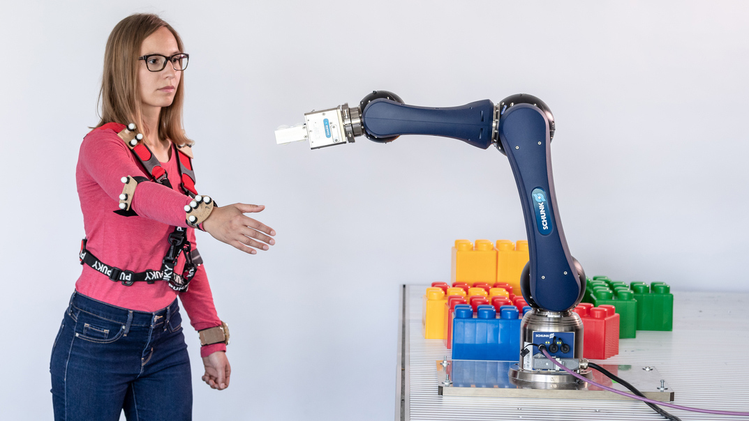 Scientist works with a robot arm